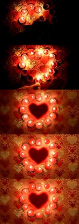Burning candles in form of heart